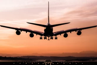 Un avion en train d'atterrir au coucher du soleil